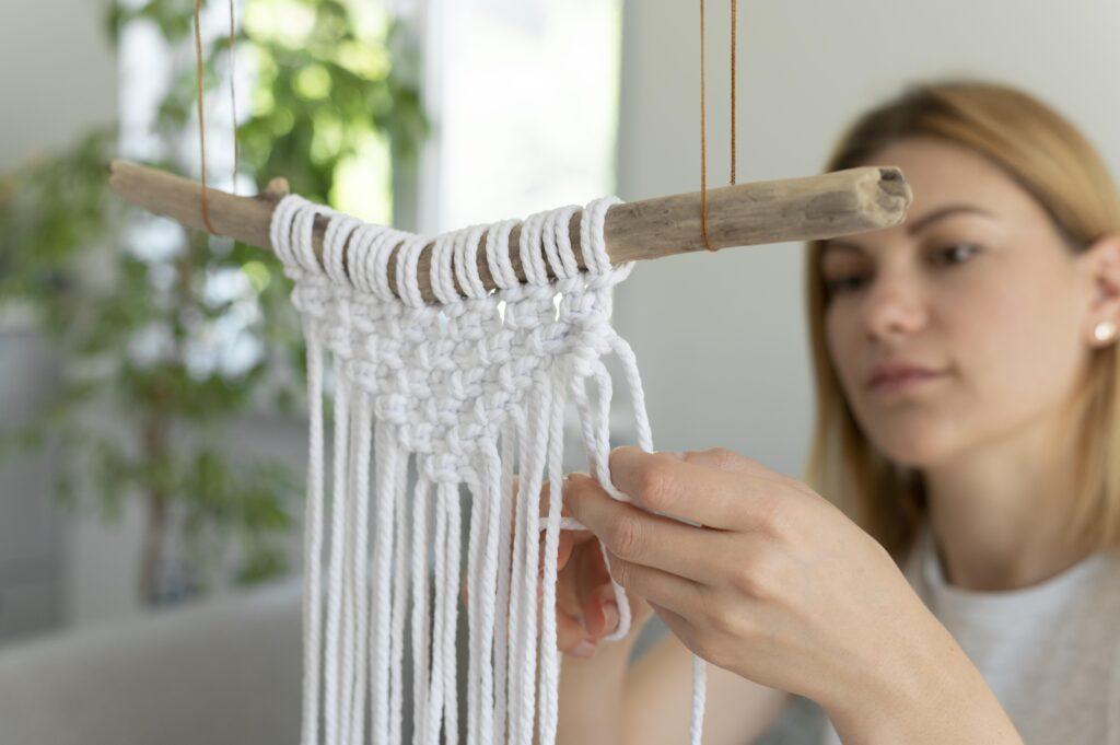 woman making a macrame for wall decor